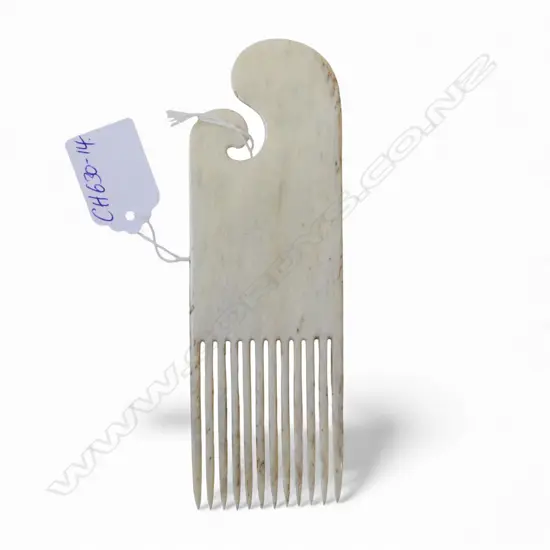 David Tuart carved whalebone heru comb with scrolling top and 12 tines. In good polish. L.155mm