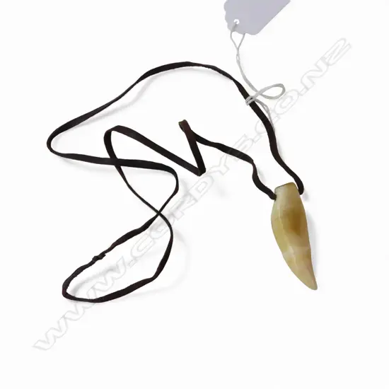 David Tuart small polished whale tooth pendant. Drilled suspension hole and with leather cord. Tooth length 51mm