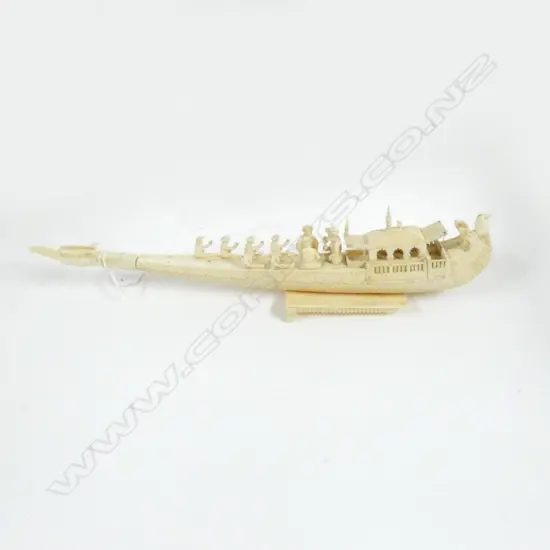 CARVED IVORY ORIENTAL BOAT ON STAND IN NEED OF REPAIR; BROKEN PIECES ACCOMPANING, L340mm