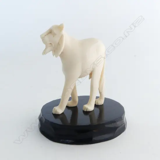 CARVED IVORY LION H.53mm on ebonised stand