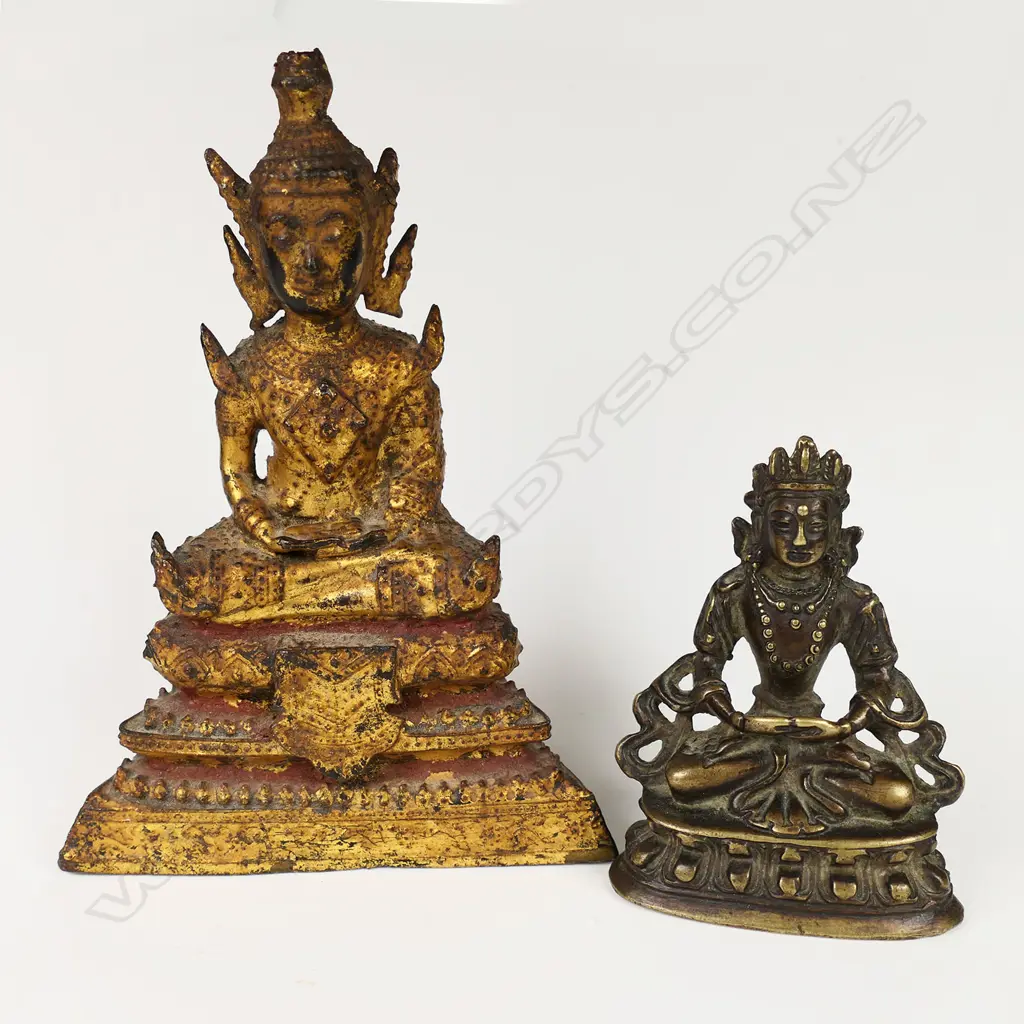 Two small buddhas; one early Rattanakosin period (18th-19thC) bronze with remnant gold leaf and red lacquer. H.110mm. The other (reputedly Ming period) bronze Sino-Tibetan - seated in dhyana mudra upon a double lotus throne. H.62mm. Provenance: The Jorgen Lotz Collection. Image 1++