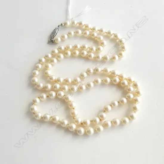 LONG STRAND UNIFORM CULTURED PEARLS individually knotted silver clasp. L.660mm. 6.2mm dia.