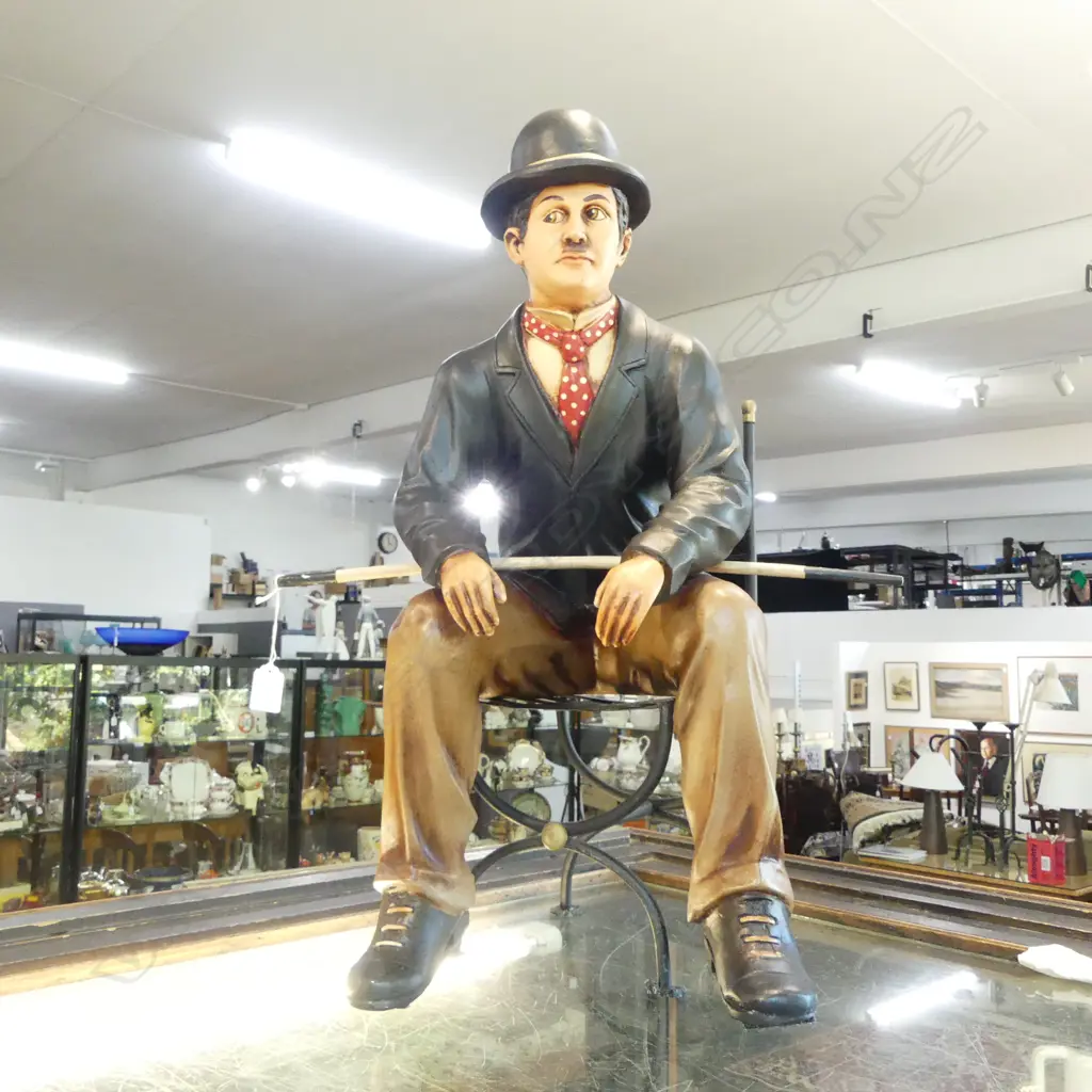 PAINTED RESIN CHARLIE CHAPLIN ON METAL CHAIR H.600mm Image 1++