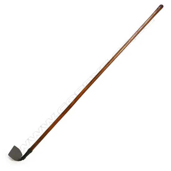 An old long handled gardener's hoe,