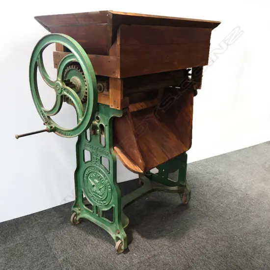 A large antique cast iron wine maker's destemmer crusher,