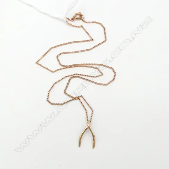 9ct GOLD WISHBONE PENDANT on rolled gold chain 0.49gms