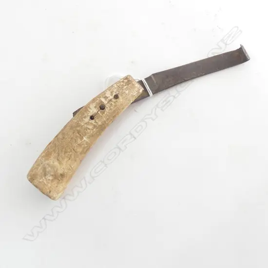 c.1900 whalebone ? and steel farrier's hoof knife handle with two pins holding the blade with hooked end. Length 212mm