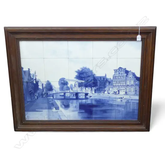 A large Dutch Delft twenty tile picture display painted in underglaze blue forming a canal town scene with figures