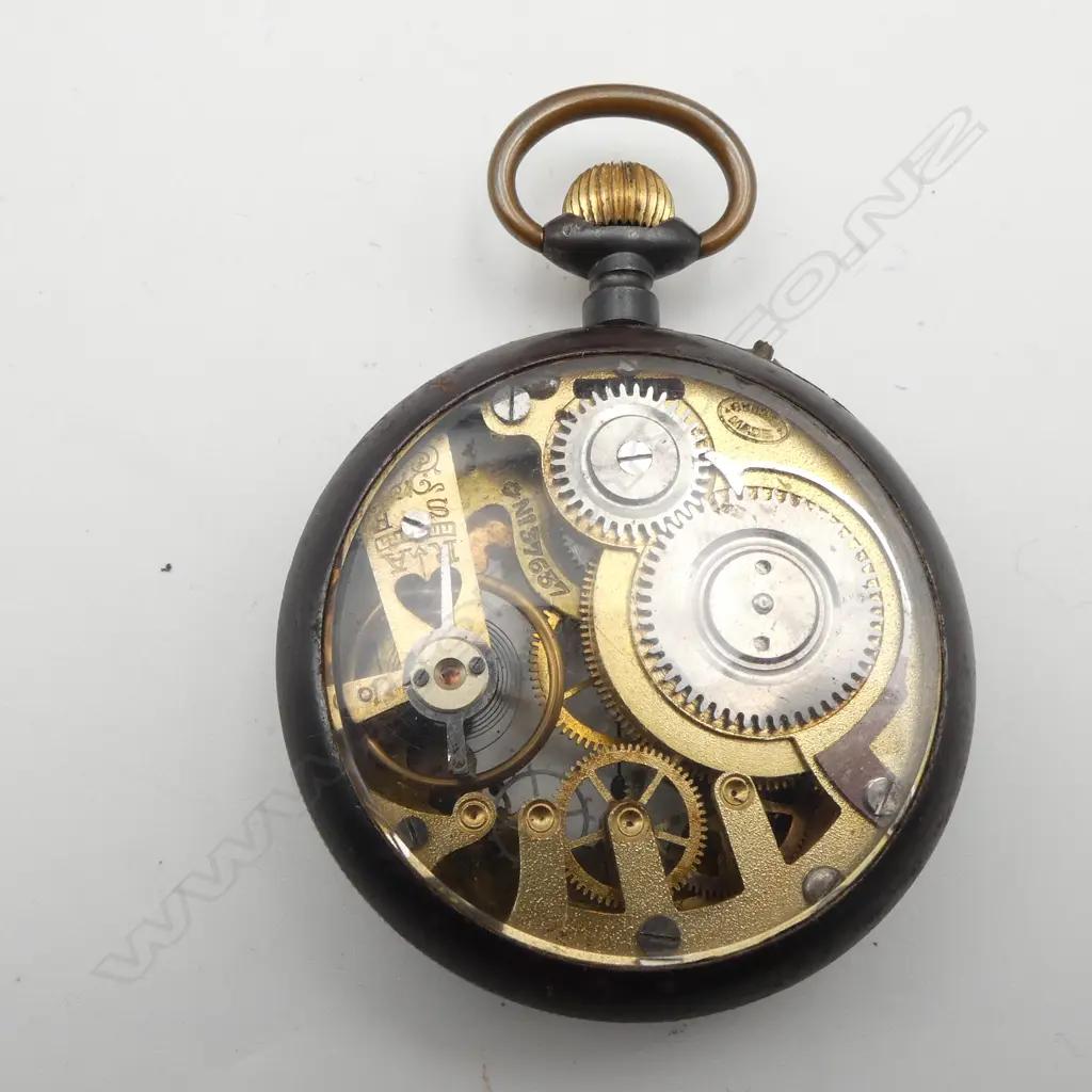 Early 20thC Swiss skeleton pocket watch exhibition back. Gun metal case. Running. In wooden stand Image 1++