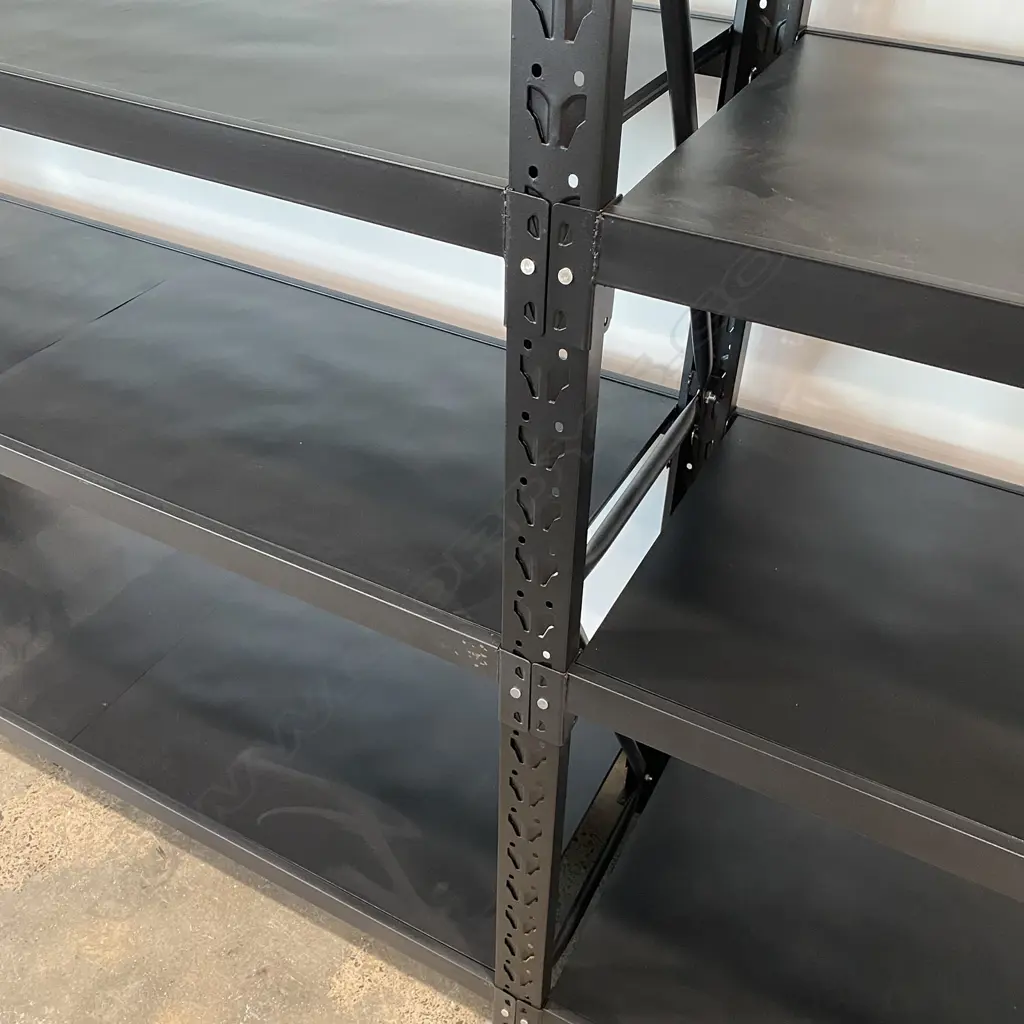 4 CONNECTED BAYS OF BLACK METAL SHELVING: Each bay with four shelves. 5 uprights. 34 shelf supports & 34 shelf sections. Image 1++
