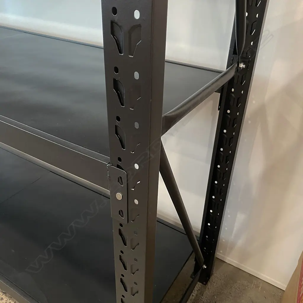 4 CONNECTED BAYS OF BLACK METAL SHELVING: Each bay with four shelves. 5 uprights. 34 shelf supports & 34 shelf sections. Image 1++