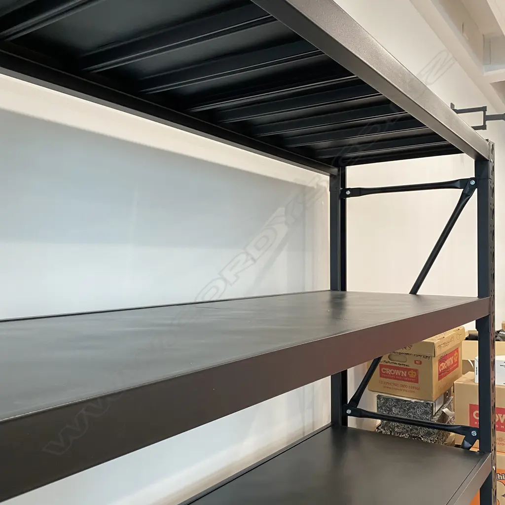 4 CONNECTED BAYS OF BLACK METAL SHELVING: Each bay with four shelves. 5 uprights. 34 shelf supports & 34 shelf sections. Image 1++