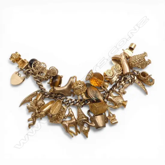 9CT GOLD CHARM BRACELET 108.37gms. laden with charms: shoes + Inn + crib + swan + antique cars etc valuation