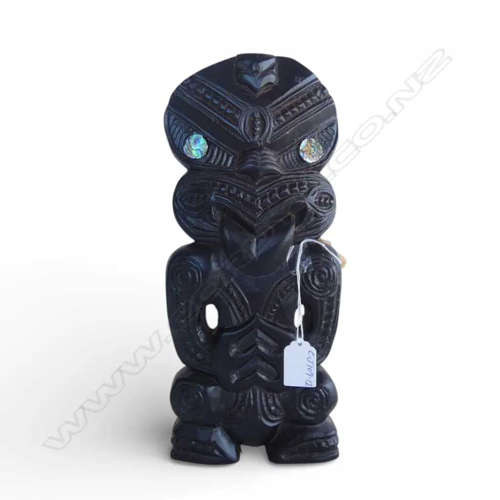 # Late 20thC Maori carved stylised figure, black polished finish. Paua disc eyes. H.315mm. Image 1++