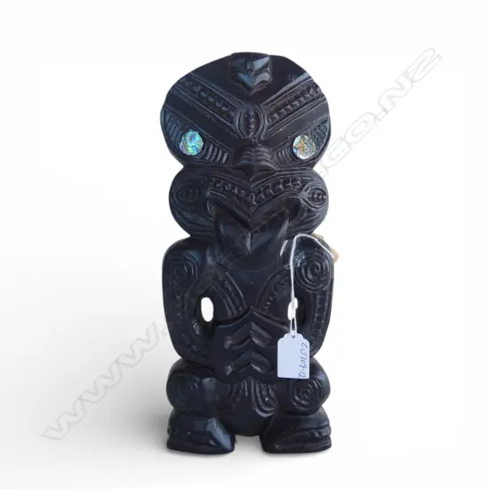 # Late 20thC Maori carved stylised figure, black polished finish. Paua disc eyes. H.315mm.