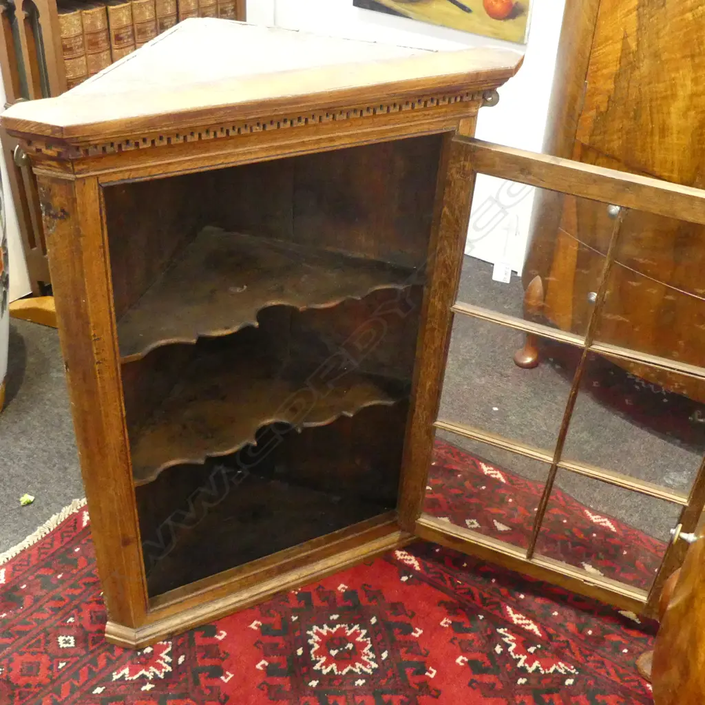 GEORGE III OAK HANGING CORNER CABINET six panel glazed door. Dentilled cornice. H.875mm Image 1++