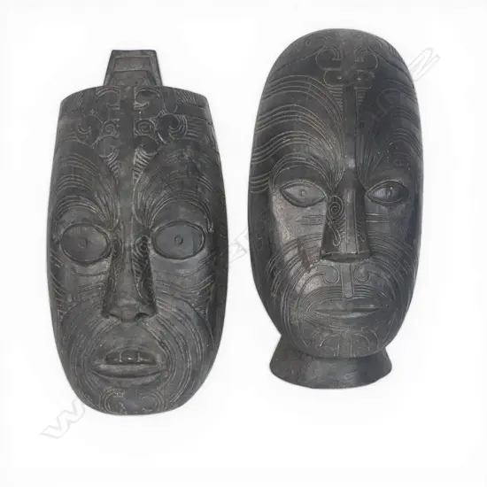 Two light weight wood Maori masks. Dark stained. H.315mm longest.