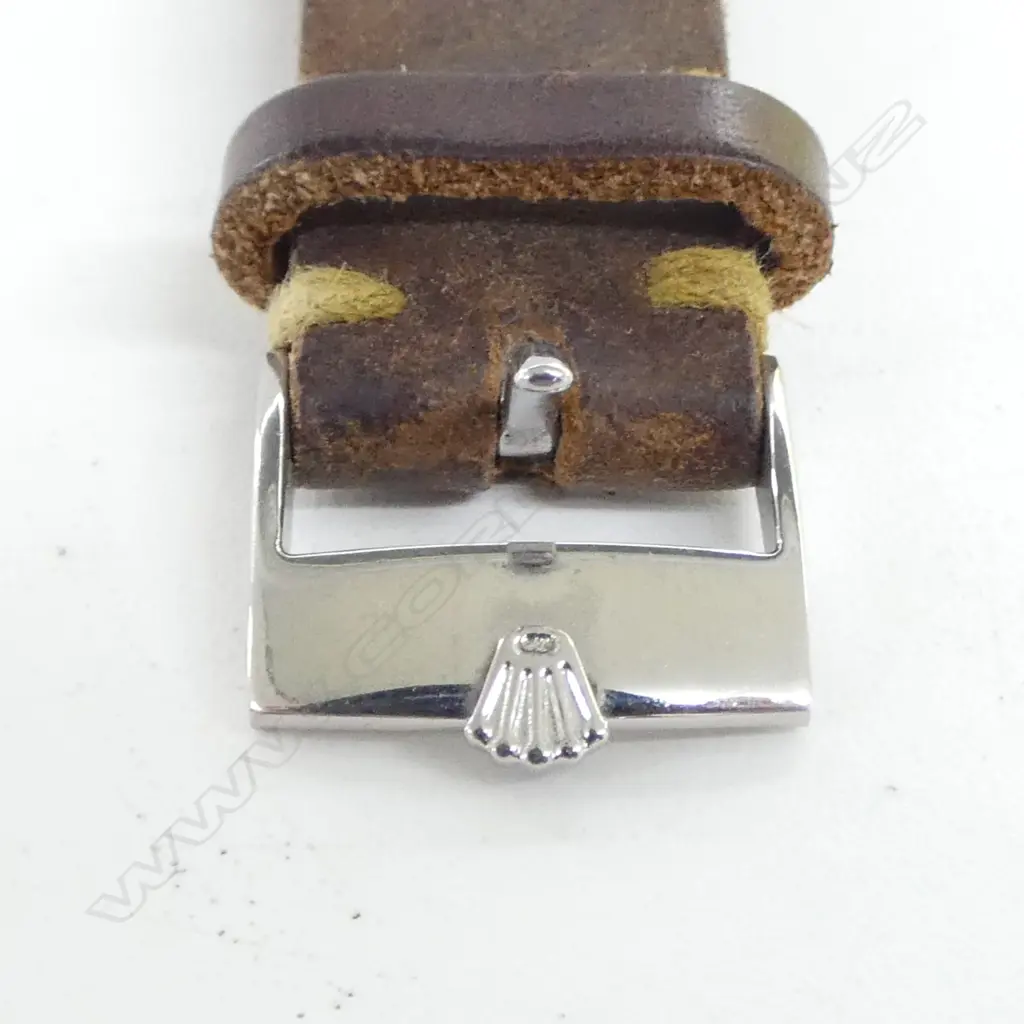 A 1950's Rolex Oyster 6144 gent's wristwatch  mid size 33mm diameter stainless steel case wind down Rolex crown. baton markers, the cream toned dial named and with 'Oyster' and 'Shock-Resisting'. Working. Later old brown leather strap with Rolex branded clasp. Image 1++