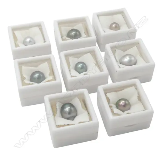 EIGHT SINGLE BOXED 'C' GRADE BLACK PEARLS From estate of jeweller Simon Misdale