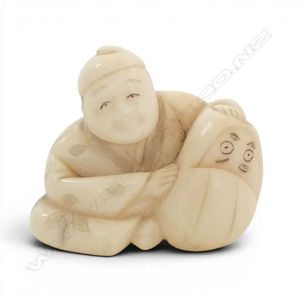JAPANESE CARVED IVORY NETSUKE of a seated man  Image 1++