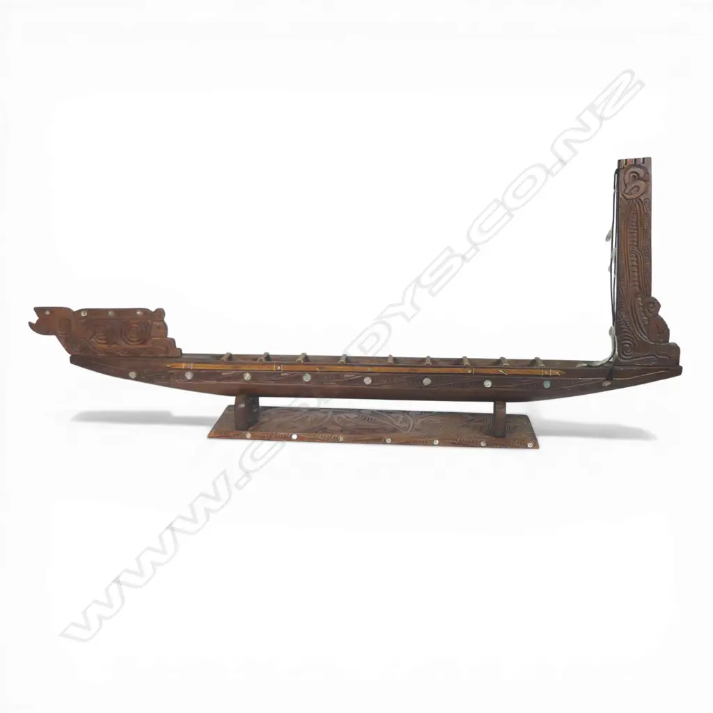 A large mid/late 20thC Māori carved wood model waka on carved stand, Image 1++