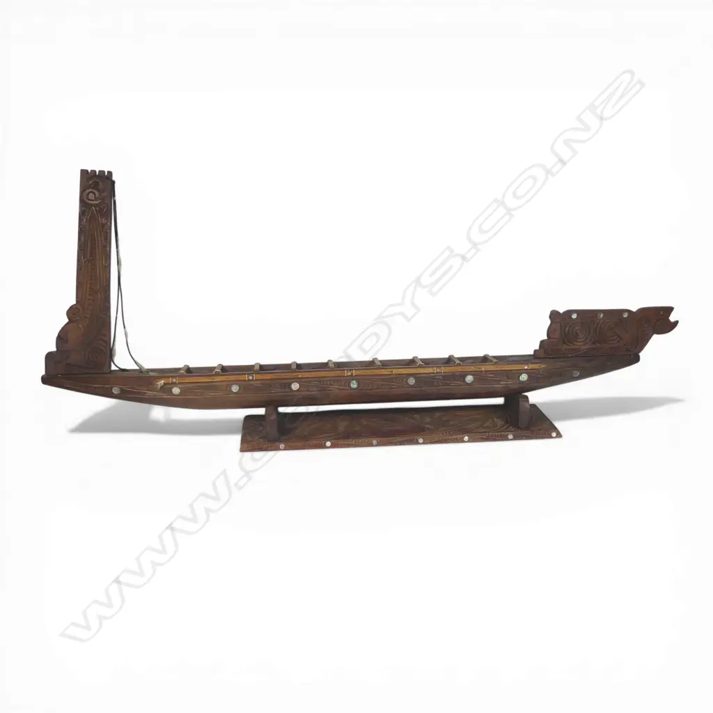 A large mid/late 20thC Māori carved wood model waka on carved stand, Image 1++