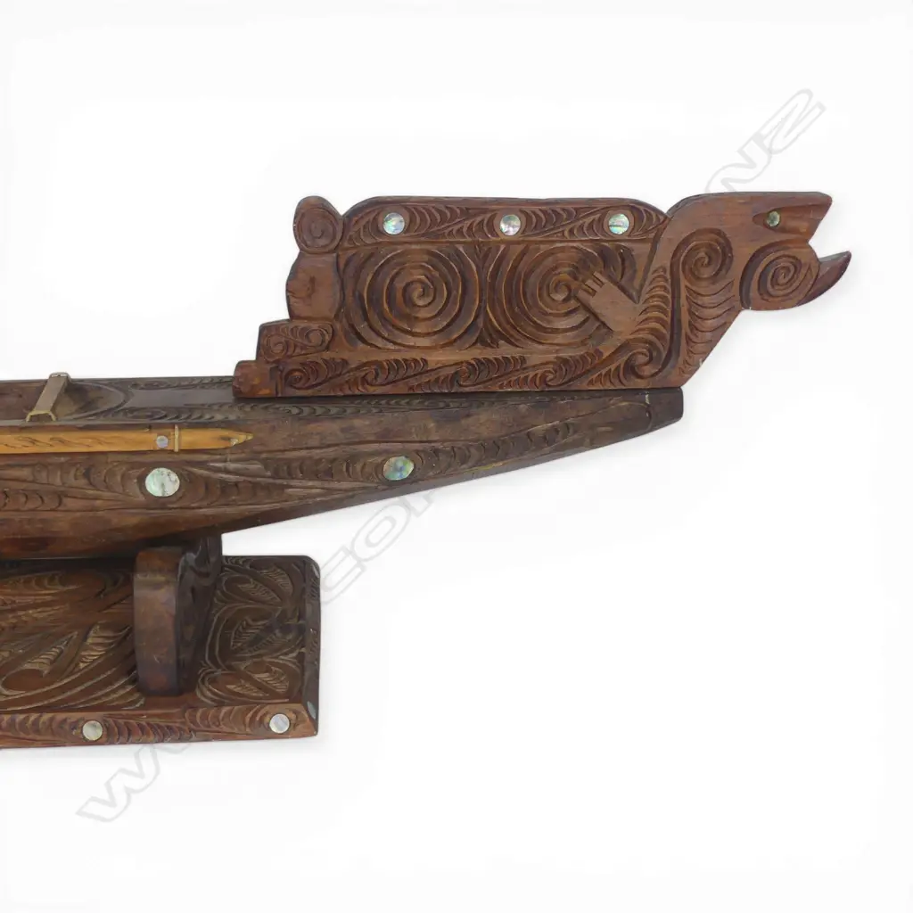 A large mid/late 20thC Māori carved wood model waka on carved stand, Image 1++