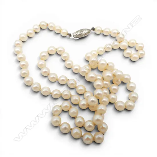 VINTAGE LONG CULTURED PEARL NECKLACE slightly graduating L.600mm. Silver clasp. Small peal missing from top of clasp.