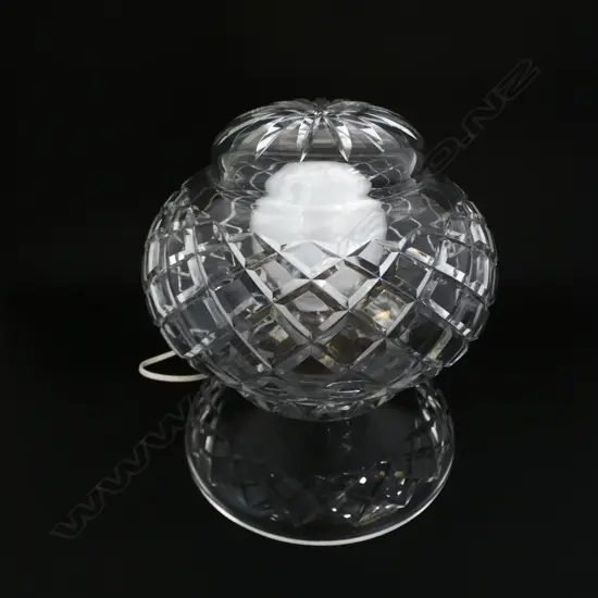 A large impressive crystal table lamp with wide round base with wheel cut decoration