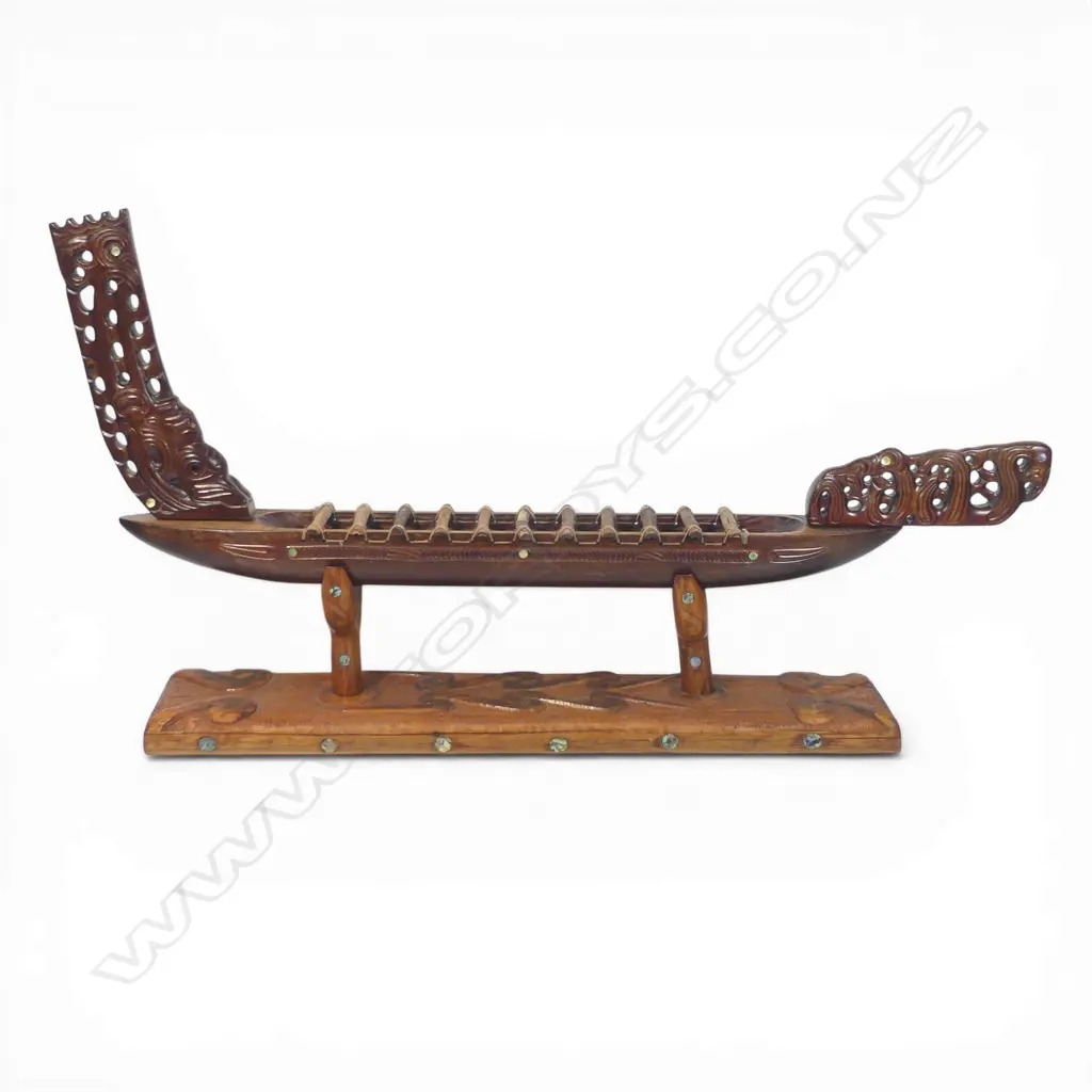 A large mid/late 20thC Māori carved wood model waka on carved stand, Image 1++