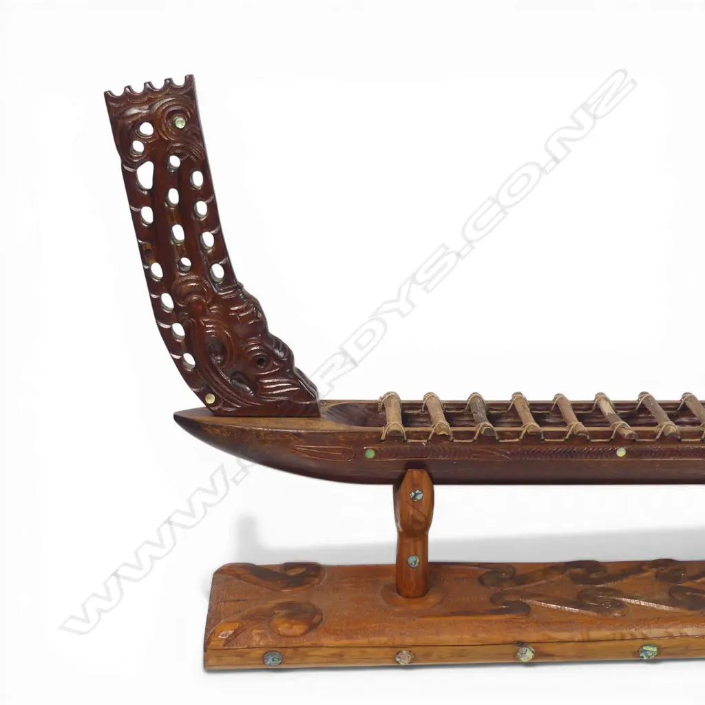 A large mid/late 20thC Māori carved wood model waka on carved stand, Image 1++