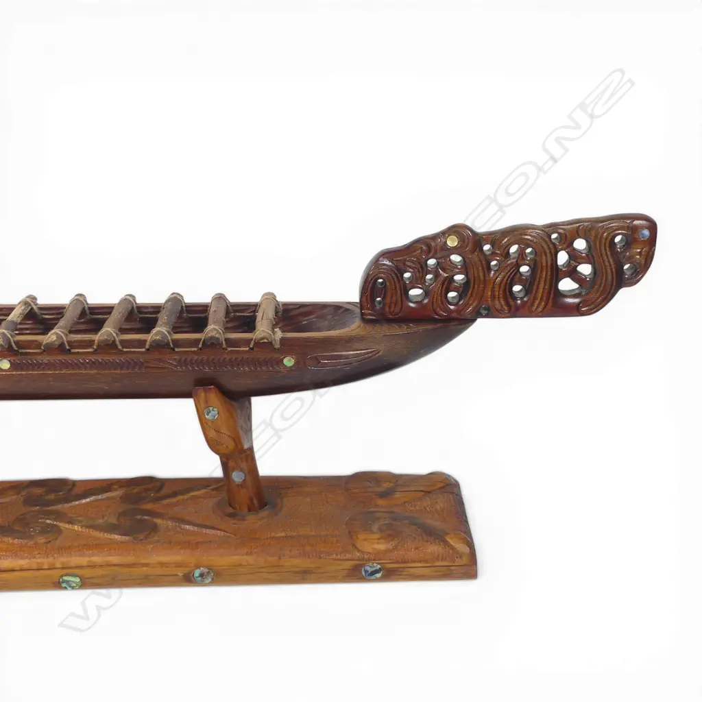 A large mid/late 20thC Māori carved wood model waka on carved stand, Image 1++
