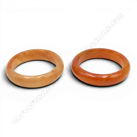 2 JADEITE RINGS amber toned. Both size J 