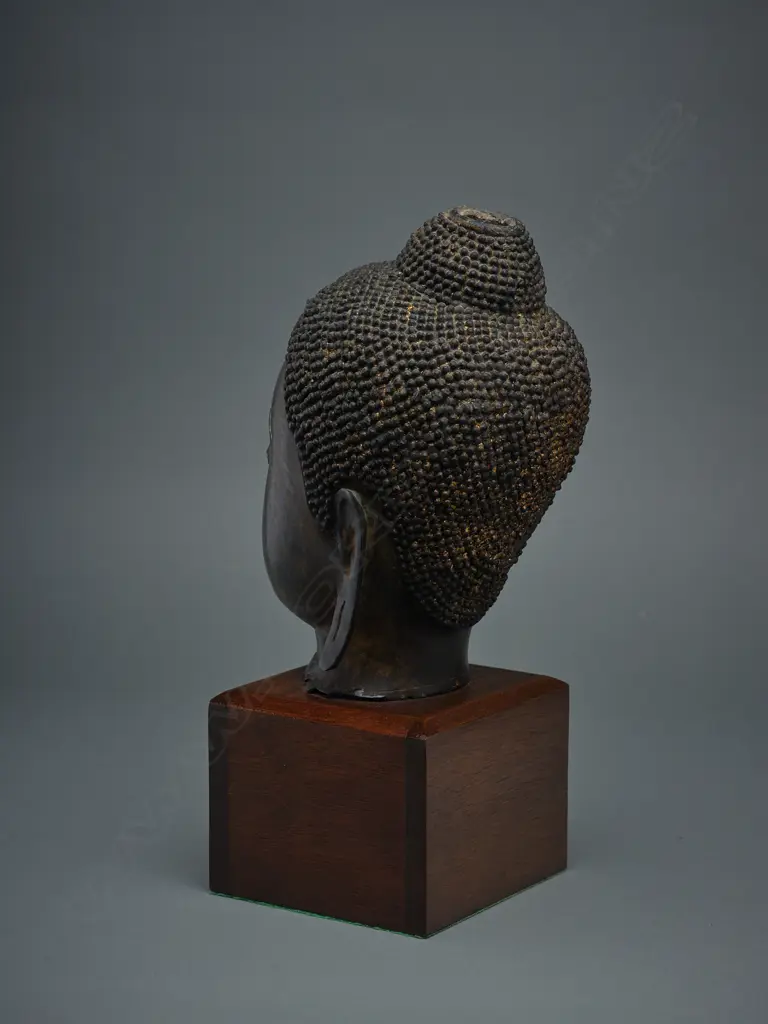 Thai bronze Buddha head fragment, mounted on wooden stand, H.320mm, some traces of gilding Image 1++