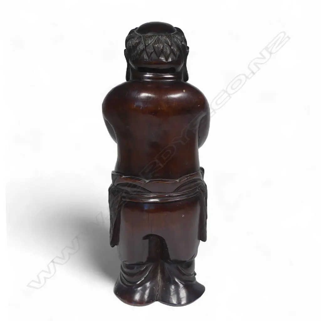 A 19thC Chinese carved hardwood Buddha figure standing with arms crossed wearing a drape around his waist. Old shrinkage crack to front and repair to foot. Good old patina. H.325mm. Image 1++