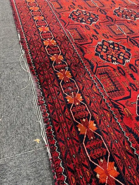 Very large Afghan Baluchi hand knotted carpet w repeating medallion design. Red ground. 3900 x 3000mm threads exposed Image 1++