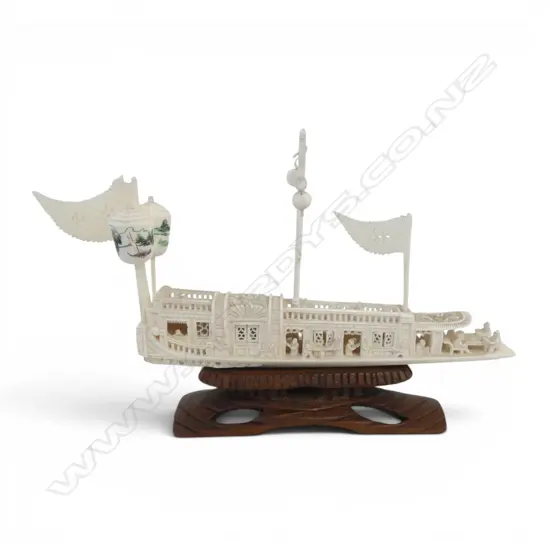 CHINESE CARVED IVORY JUNK BOAT with opening windows, on carved wood stand, chip to boat front L.180mm