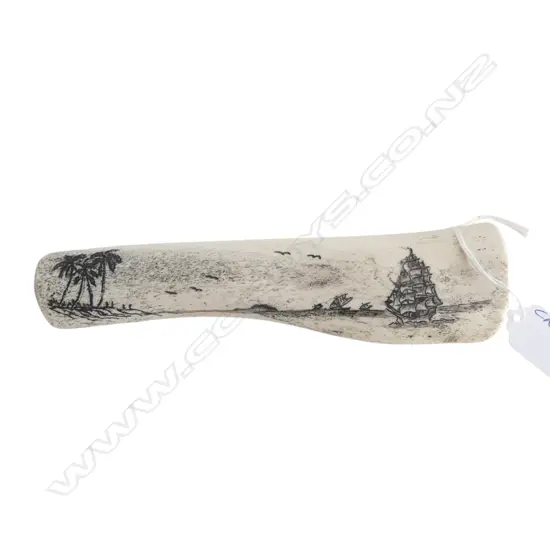 20thC Tongan scrimshaw on cow bone. Coastal tropical scene w sailing ship. L.190mm