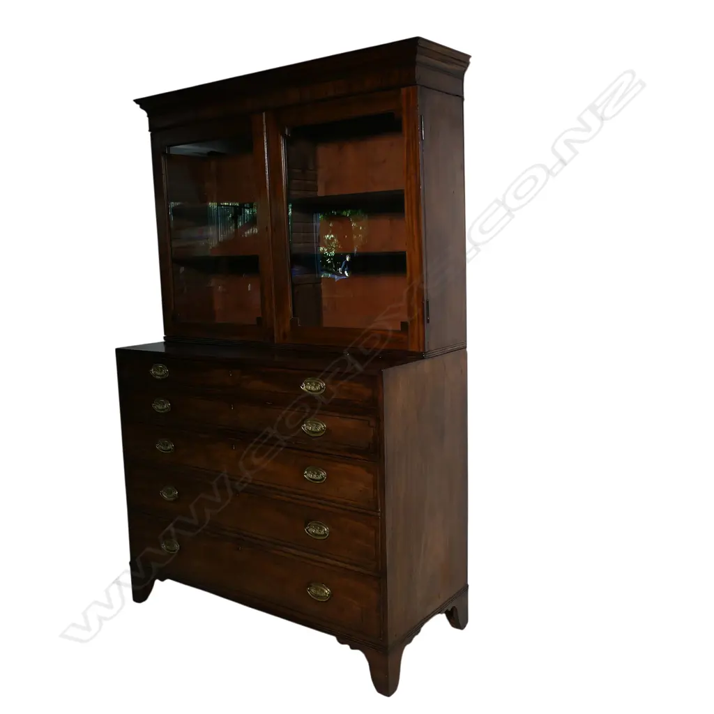 A Victorian or earlier mahogany bookcase/secretaire the glazed top with restrained pediment and two interior shelves the base with secretaire drawer over three full width drawers raised on bracket feet. The top of the same period possibly not original to the base. 1270 x 540 x 2050mm. Image 1++