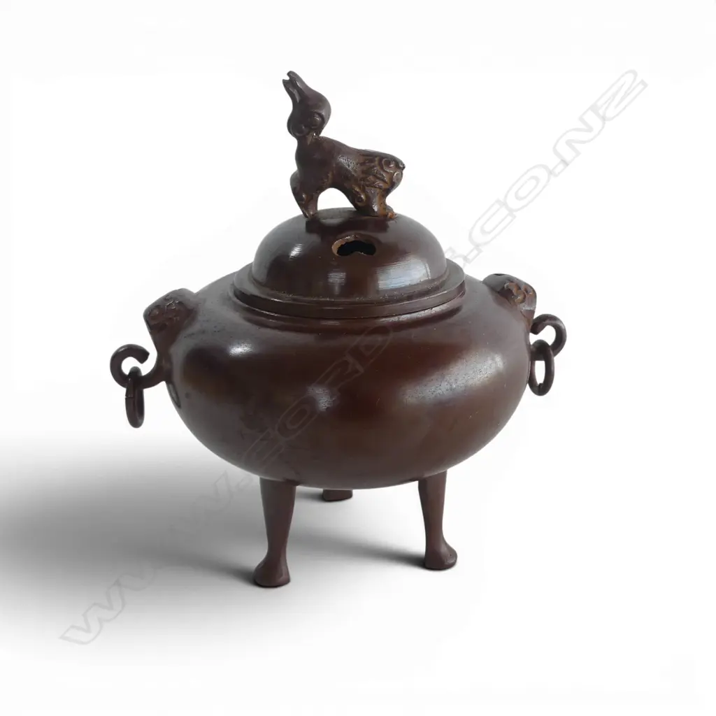 ORIENTAL BRONZE INCENSE BURNER Shishi finial & mask handles. Raised on 3 tall feet. H.140mm. Image 1++