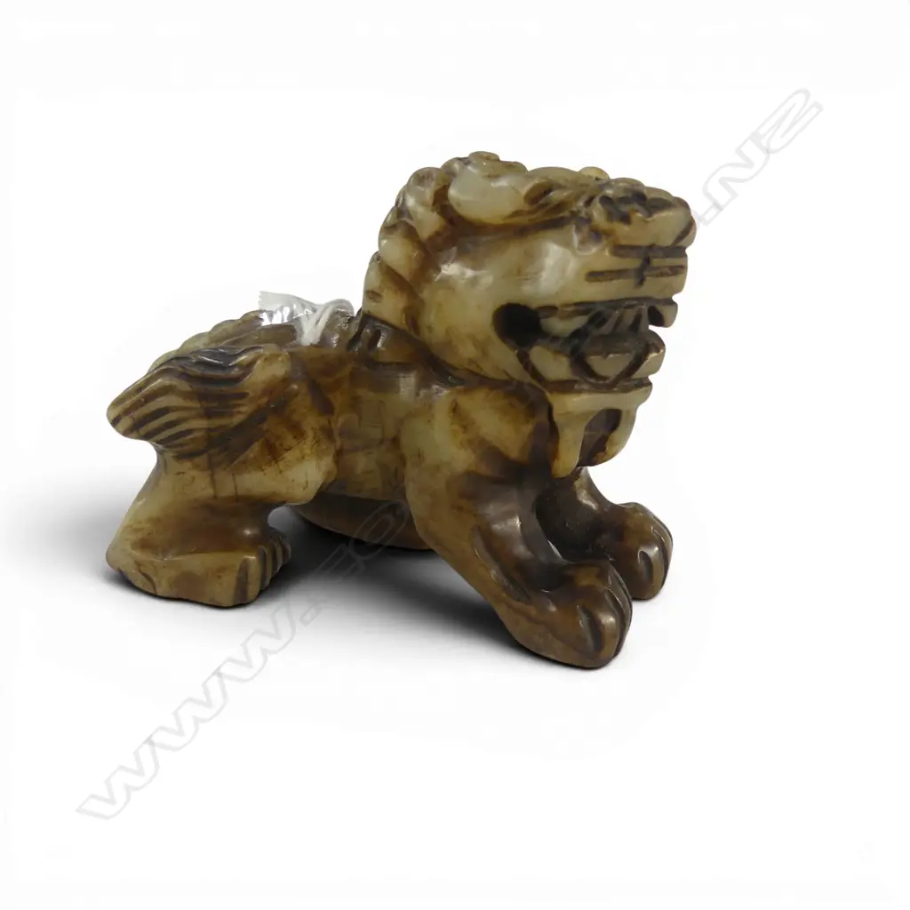 CHINESE PALE GREEN SMALL CARVED SNARLING LION L.85mm. Partial dark stained finish. Image 1++