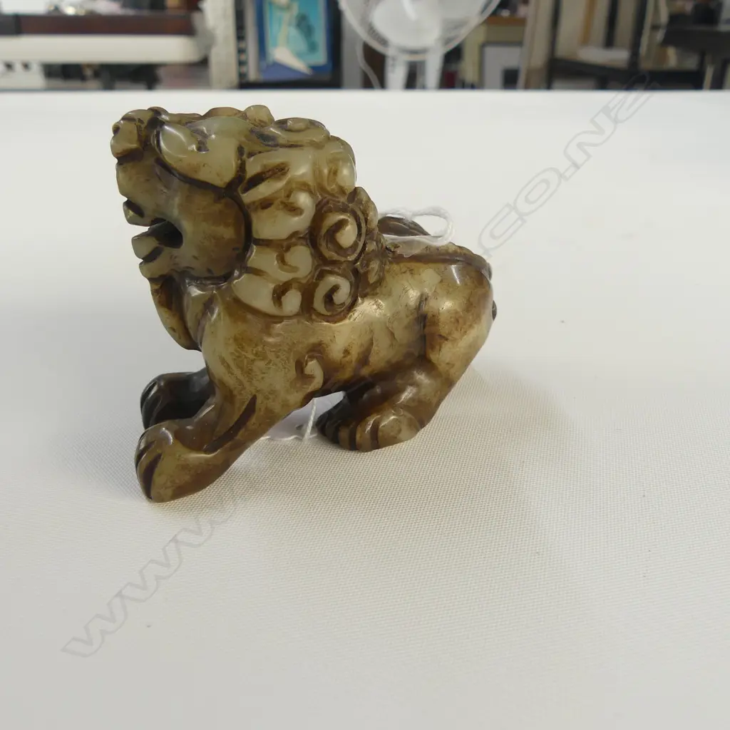 CHINESE PALE GREEN SMALL CARVED SNARLING LION L.85mm. Partial dark stained finish. Image 1++