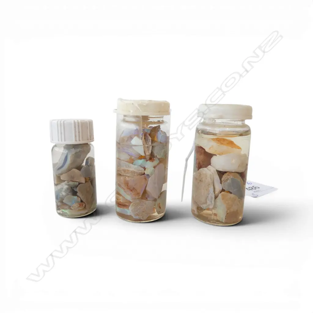 3 small glass bottles of opal specimens in liquid. H.55mm. Image 1++
