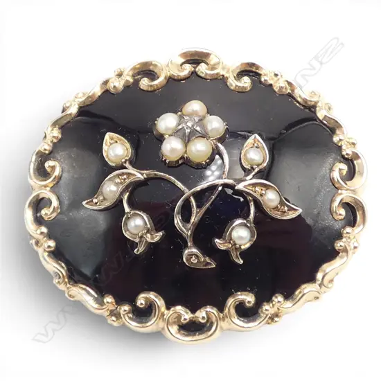 # Victorian 9ct gold black enamel and pearl mourning brooch, with hair locket to reverse.20gms. 
