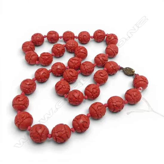 NECKLACE OF OLD CINIBAR LACQUER TYPE CARVED BEADS uniform size individually knotted. L.640mm.