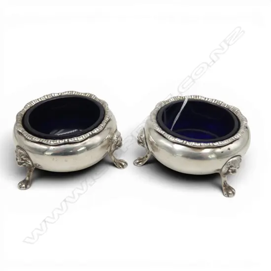 # Pair of silver salts w blue glaze liners. Birmingham 1931. Lion's mask feet mounts. 174gms silver.