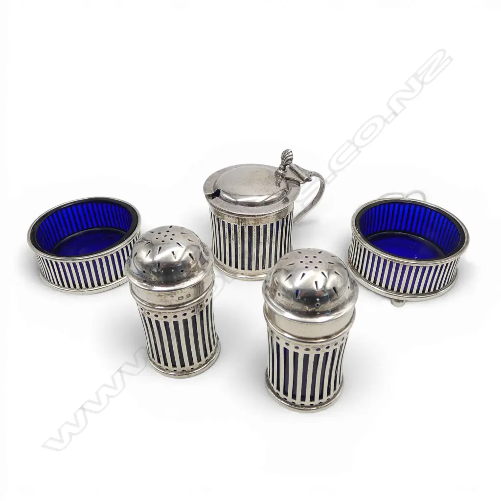 Silver 5 pce cruet set.Pierced + Bristol blue glass liners: Mustard pot + 2 pepperettes + 2 salts. Silver weight 196gms. Image 1++
