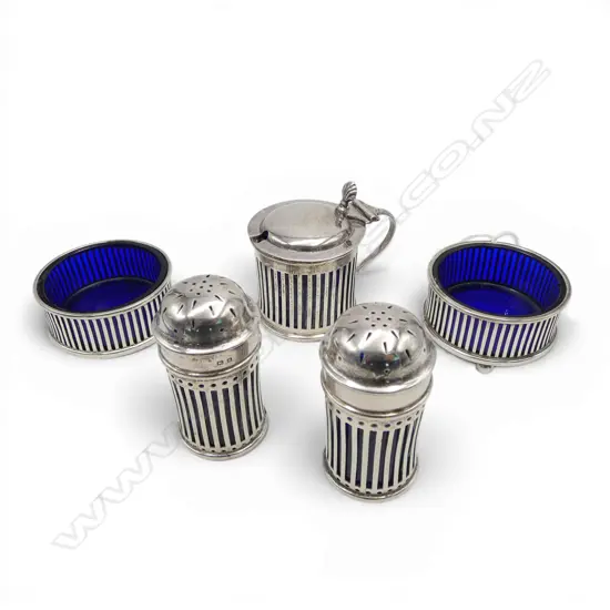 Silver 5 pce cruet set.Pierced + Bristol blue glass liners: Mustard pot + 2 pepperettes + 2 salts. Silver weight 196gms.