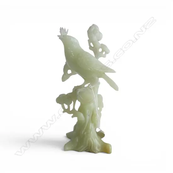 CHINESE PALE GREEN JADE CARVED BIRD ON PINE TREE. creamy tone. Well carved. Tiny chip to lower beak. H.195mm.