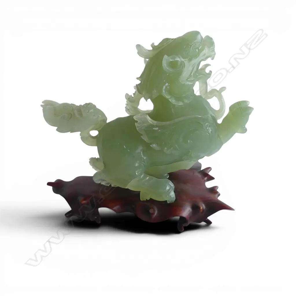 CHINESE PALE GREEN JADE CARVING OF A DRAGON with young the tail broken and restuck etc. ON WOOD STAND. H.180mm Image 1++